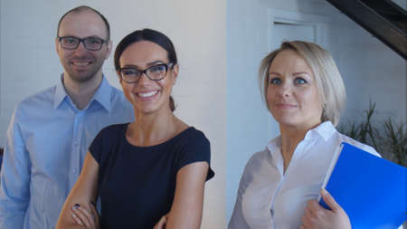 Teamwork of young people at the office looking to the camera and smilingの写真素材