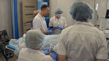 Doctors performing endoscopic procedure in hospitalの写真素材