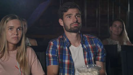 Young couple watching a movie at the cinemaの写真素材