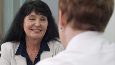 Therapeutic taking care of her client in hospital roomの写真素材