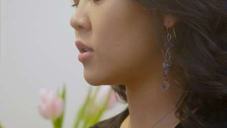 Attractive brunette tries on an earring and talkingの写真素材