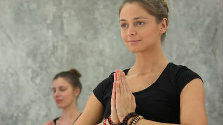 Beautiful women yoga trainer practicing in yoga classの写真素材
