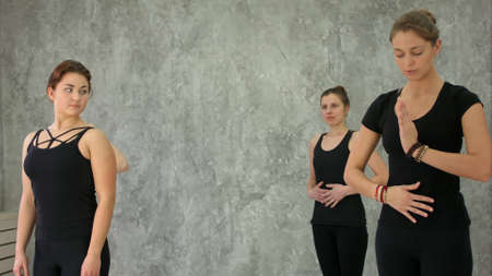 Group of young woman doing exercise for breathing in yoga classの写真素材