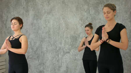 Beautiful young women meditating in studioの写真素材