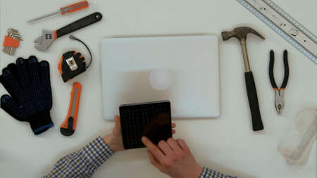 Architect male hands using digital tablet in the office. Close up. Top view.の写真素材