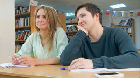 Students in class listening to a tutorの写真素材