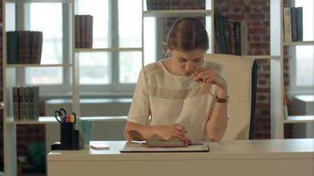 businesswoman in the office at the table working on the touch pad tablet gadget.の写真素材