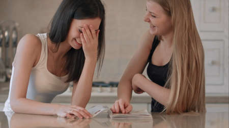 Two Girls reading fashion Magazineの写真素材