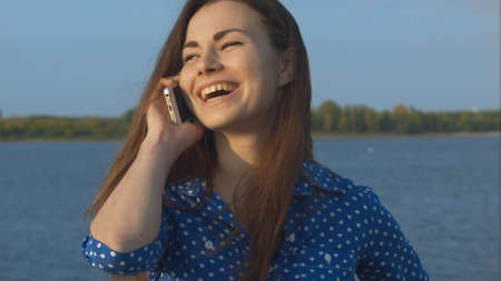 Beautiful woman calling with mobile phone. Closeup.の写真素材
