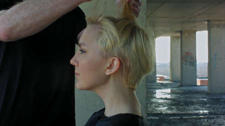 Beautiful blond woman gets a hairdress.の写真素材