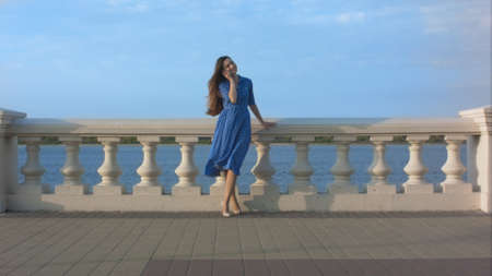 Woman calling on cell phone outdoor.の写真素材