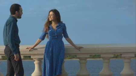 Young woman meets a man. Waterfront.の写真素材