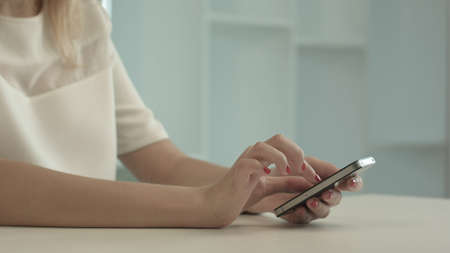 Woman touching and browsing her smart phoneの写真素材
