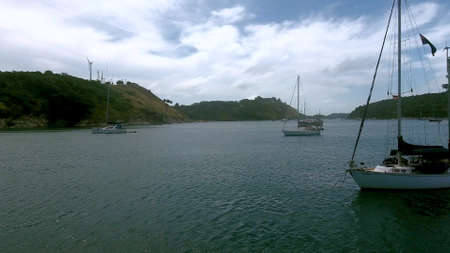 Aerial view of yachts moored in a bay near old fishing villageの写真素材