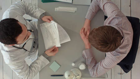 Doctor discussing a patients results. Top viewの写真素材