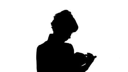 Silhouette Concentrated young business woman holding and reading book track matteの写真素材