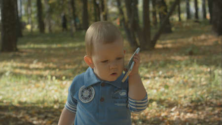 Adorable baby stops calling with cell phone.の写真素材