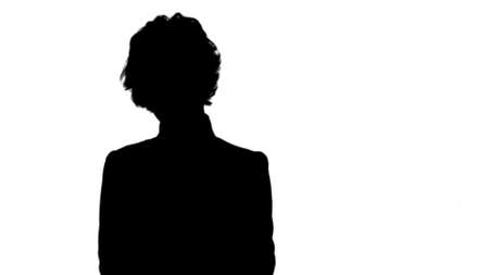 Silhouette Young beautiful business woman in a suit, smiling, happy, working with a tablet, writing a message track matteの写真素材