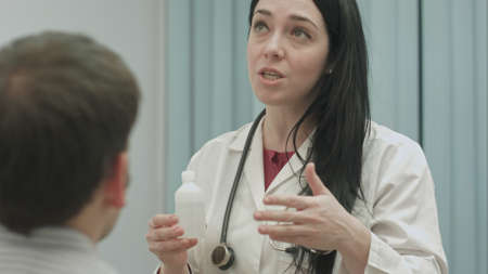 Female doctor recommending and talks about effect of drugs to patientの写真素材