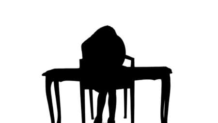 Silhouette Cute little girl doing homework, writing down track matteの写真素材