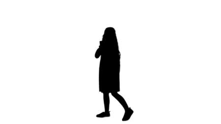 Silhouette Happy little girl take a selfie with a smart phone track matteの写真素材