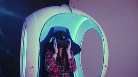 Young woman putting on virtual reality headset preparing for vr sessionの写真素材