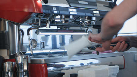Barista using coffee machine preparing fresh coffeeの写真素材