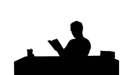 Silhouette Portrait of a male student reading a bookの写真素材