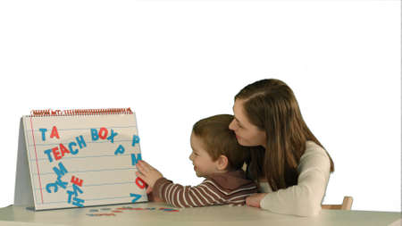 Mother and son make word Mama on the desk on white background isolatedの写真素材