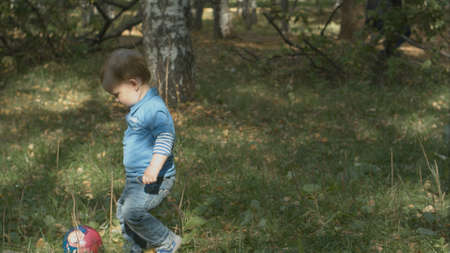 Little boy with pick up ball and throw.の写真素材