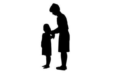 Silhouette Happy mother doing hair style for a daughter track matteの写真素材