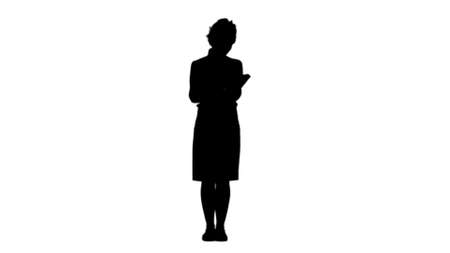 Silhouette Woman standing and reading book track matteの写真素材