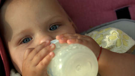 Baby sucking bottleの写真素材