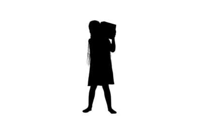Silhouette Joyful little girl holding box present in hands track matteの写真素材