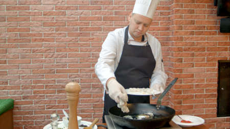 Chef putting fresh seafood to a panの写真素材
