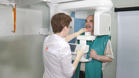 Senior patient examination of teeth by using panoramic and cephalometric X-Ray scannerの写真素材