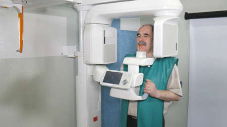 Process of examination of the patient by using panoramic and cephalometric X-Ray scannerの写真素材
