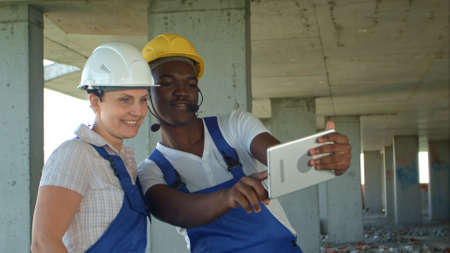 Funny workers taking selfie at contruction siteの写真素材