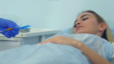 Nurse preparing female patients arm to put IV tubeの写真素材