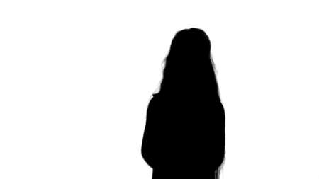 Silhouette Positive teen girl talking to a camera with a smile track matteの写真素材