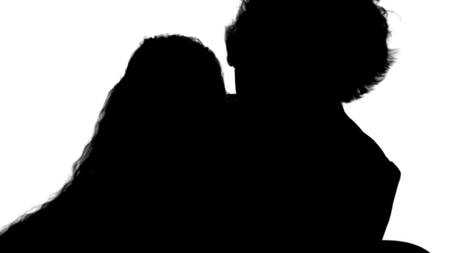 Silhouette Mother and daughter reading a book with enthusiasm track matteの写真素材