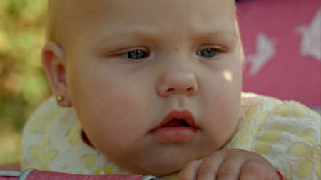Baby girl sitting a pink bunnyの写真素材
