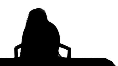 Silhouette Little girl writes to writing-book track matteの写真素材