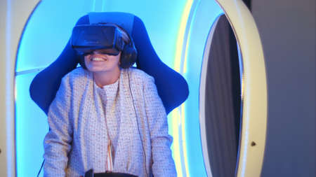 Screaming female immersing in virtual reality experience