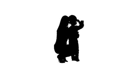 Silhouette Boy taking a selfie with her motherの写真素材
