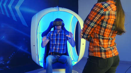 Young woman waiting for her turn for virtual reality attractionの写真素材
