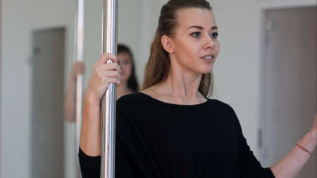 Young sexy pole dance woman exercisingの写真素材