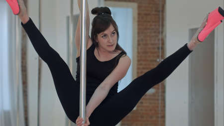 Young slim sexy pole dance woman dancing in black lingerieの写真素材