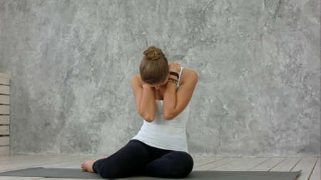 Young woman stretching her neck and looking away after yoga classの写真素材