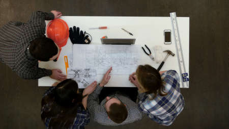 Group of young architects working on drawingsの写真素材